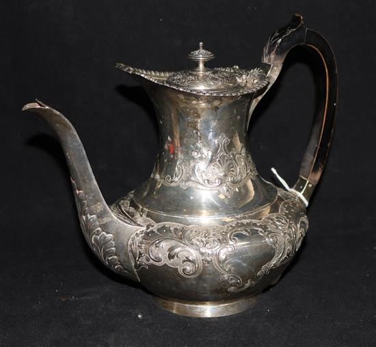 An Edwardian embossed silver coffee pot by Edward Barnard & Sons Ltd, London, 1904, gross 33 oz.